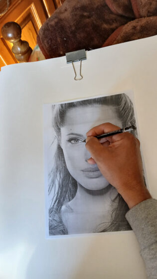     Depois de completado esse procedimento, você irá virar a página e usando um lápis grafite de preferência duro, começa a cobrir toda a imagem, dando máxima atenção aos olhos, no qual é o elemento principal nesse tipo de trabalho.
Uma observação importante no caso da barra de grafite que irá riscar toda a folha atrás, esse grafite precisa ser macio, pelo menos 8B, para que os riscos fiquem mais escuros e definidos no momento de riscar os traços, a imagem que aparecerá será mais nítida.
E o lápis grafite para efetuar o desenho de preferência duro, como o que uso nesse trabalho, o 6H, para que possa vincar bem e deixar a marca do grafite na folha que está sendo usada.
